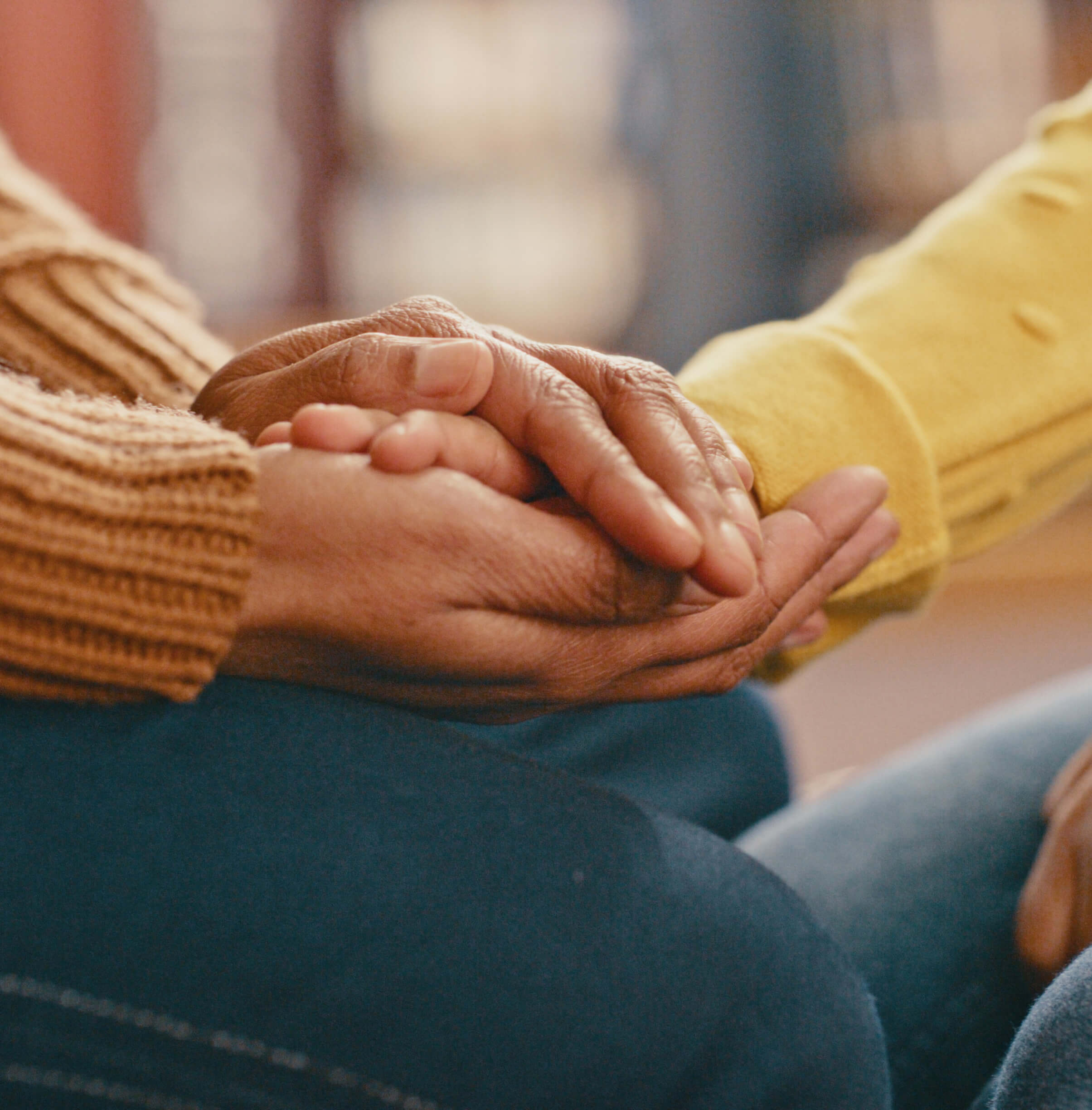 Hands, love and care touching in support, trust or unity for community, compassion or understanding. People holding hands in respect for loss, affection or passion for listening, talk or time
